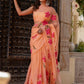 Elegant peach chiffon saree with floral design, perfect for festive occasions and celebrations