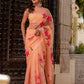 Elegant peach chiffon saree with floral design, featuring vibrant pink flowers for special occasions