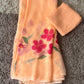 Peach chiffon saree with floral design accompanied by a matching scarf for elegant styling