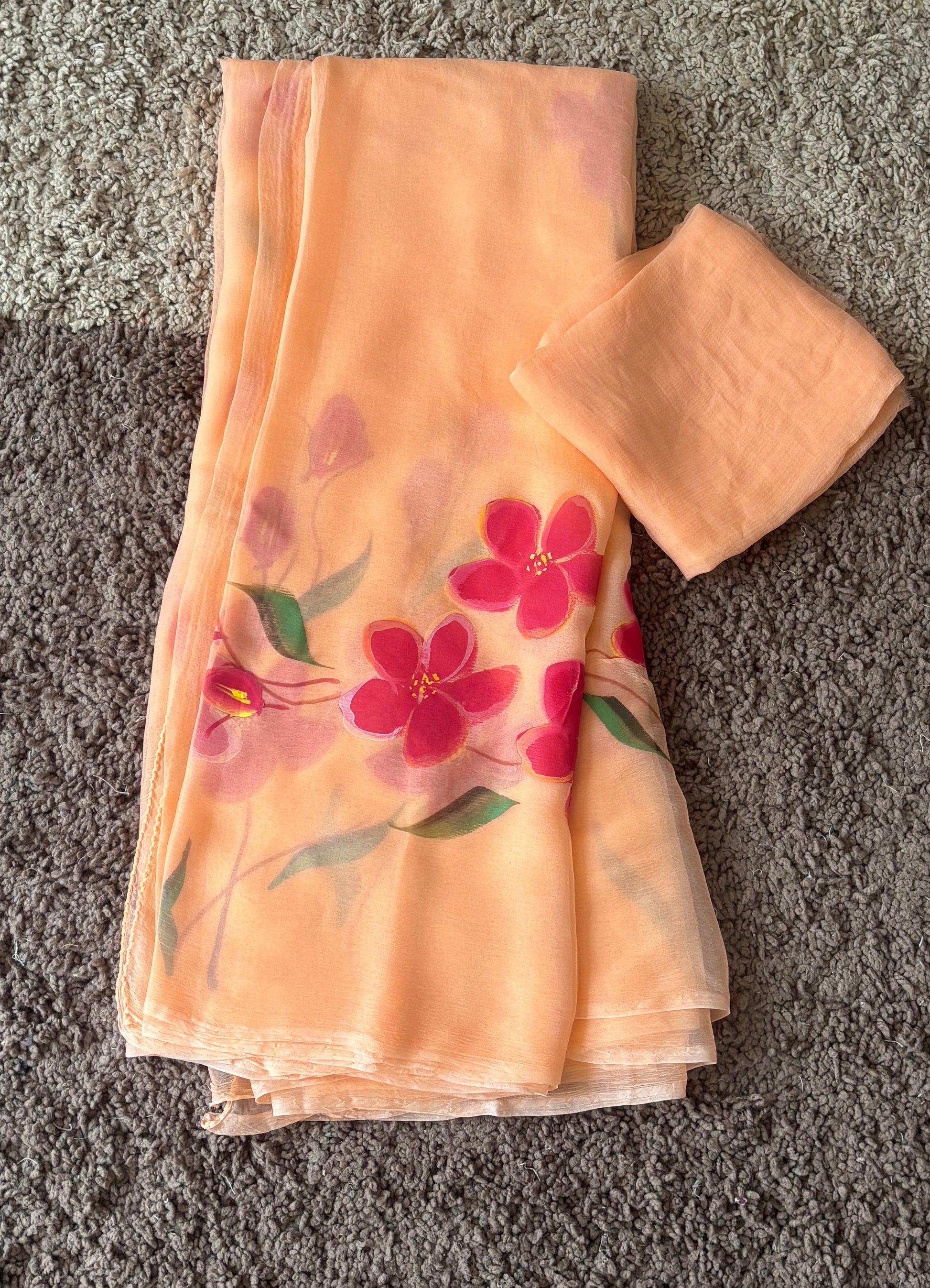 Peach chiffon saree with floral design accompanied by a matching scarf for elegant styling