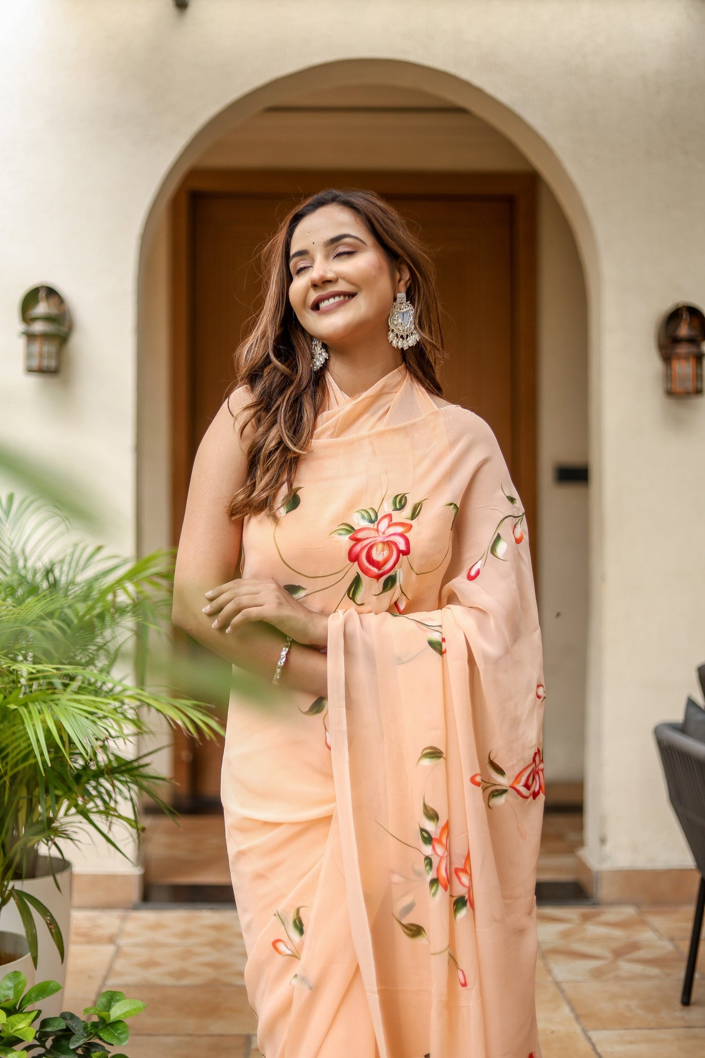 Elegant peach floral saree for women with intricate embroidery, perfect for festive occasions