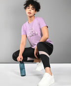 Women wearing a Pilates pink t-shirt featuring a stylish design with love in a workout setting