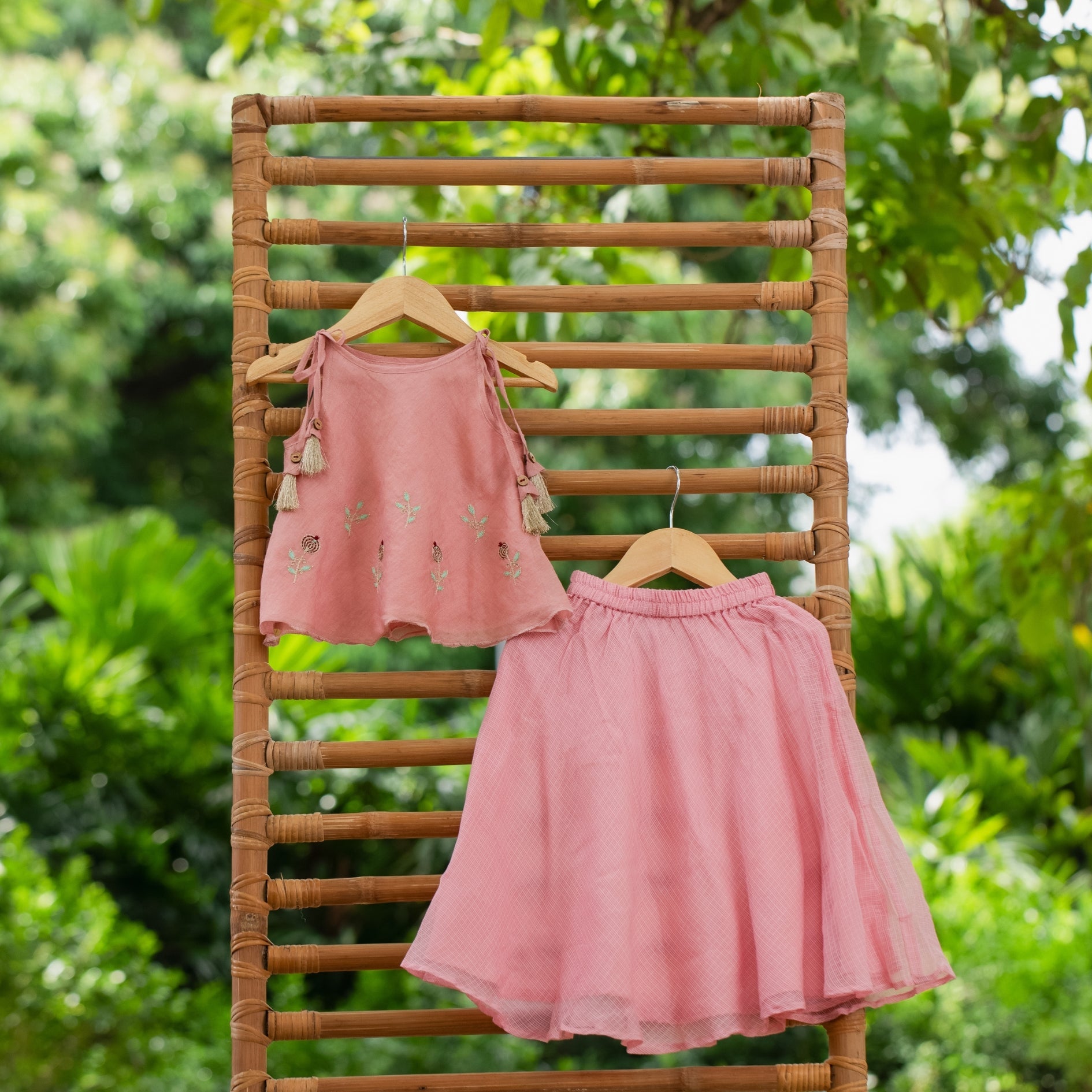 Pink festive skirt set featuring a matching top with floral embroidery and a flared skirt