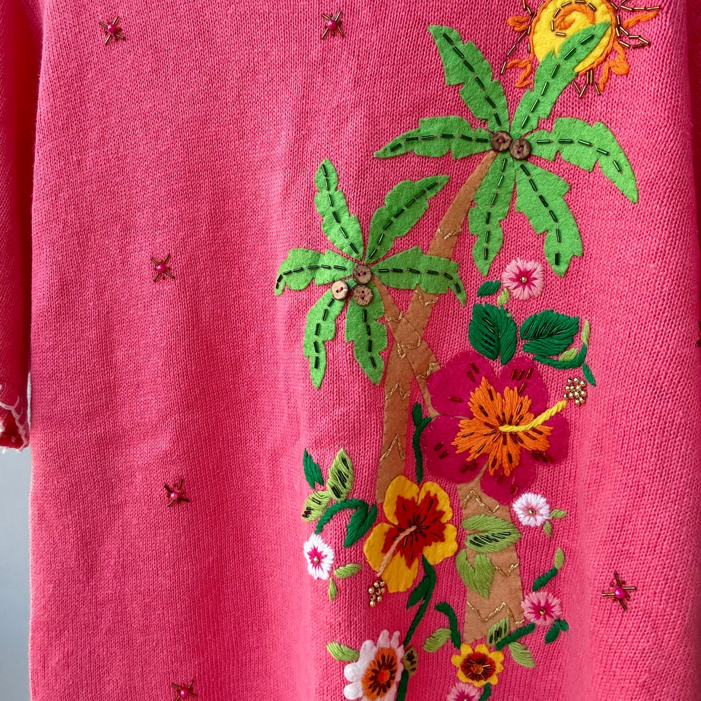 pink floral oversized pullover with embroidered tropical palm tree and colorful applique flowers and bead details