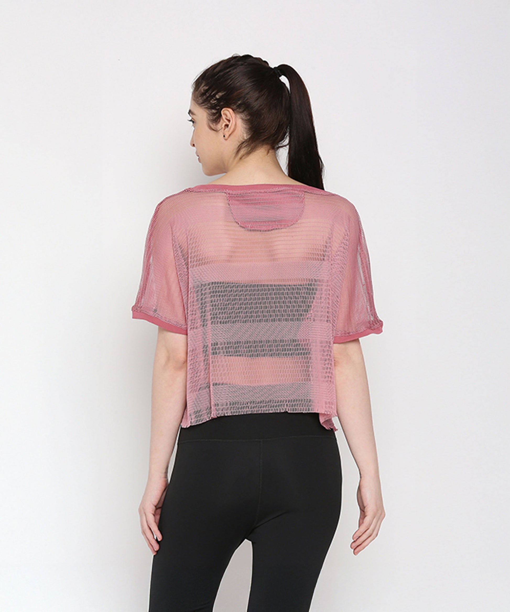 Back view of a pink netted top for women, designed for comfort and style during workouts