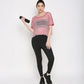 Pink netted top for women paired with black leggings and holding a fitness bottle