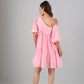 Model wearing Stylera pink off shoulder dress back view tiered mini with puff sleeves and one shoulder detail