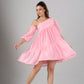 Model wearing pink off shoulder dress with tiered skirt and puff sleeves twirling in nude heels