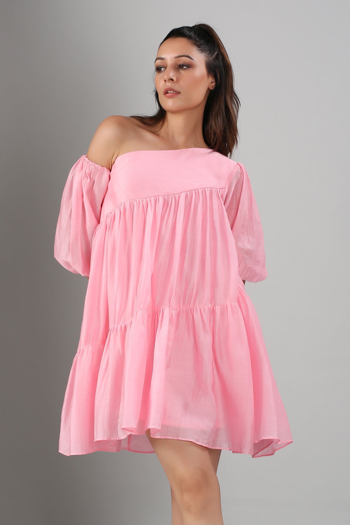 Model wearing Stylera pink off shoulder dress with puff sleeves tiered babydoll silhouette for summer