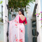Elegant pink saree for women with floral embroidery, styled with a matching blouse and an open-back design