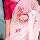 Elegant pink saree for women adorned with floral designs, paired with a stylish pink blouse