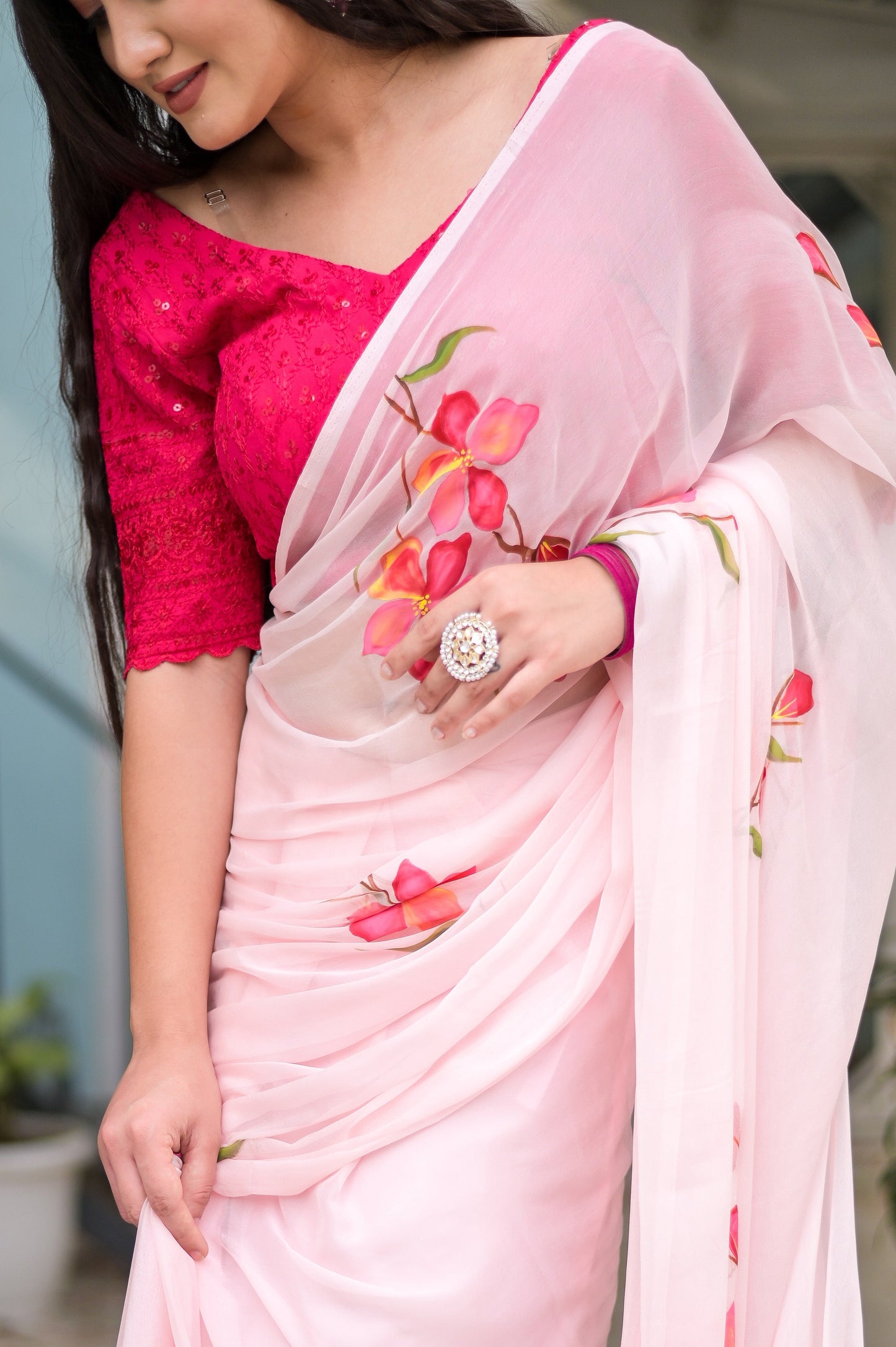 Elegant pink saree for women adorned with floral designs, paired with a stylish pink blouse