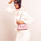 Stylish pink shoulder bag for women from Stylera, worn with a chic outfit