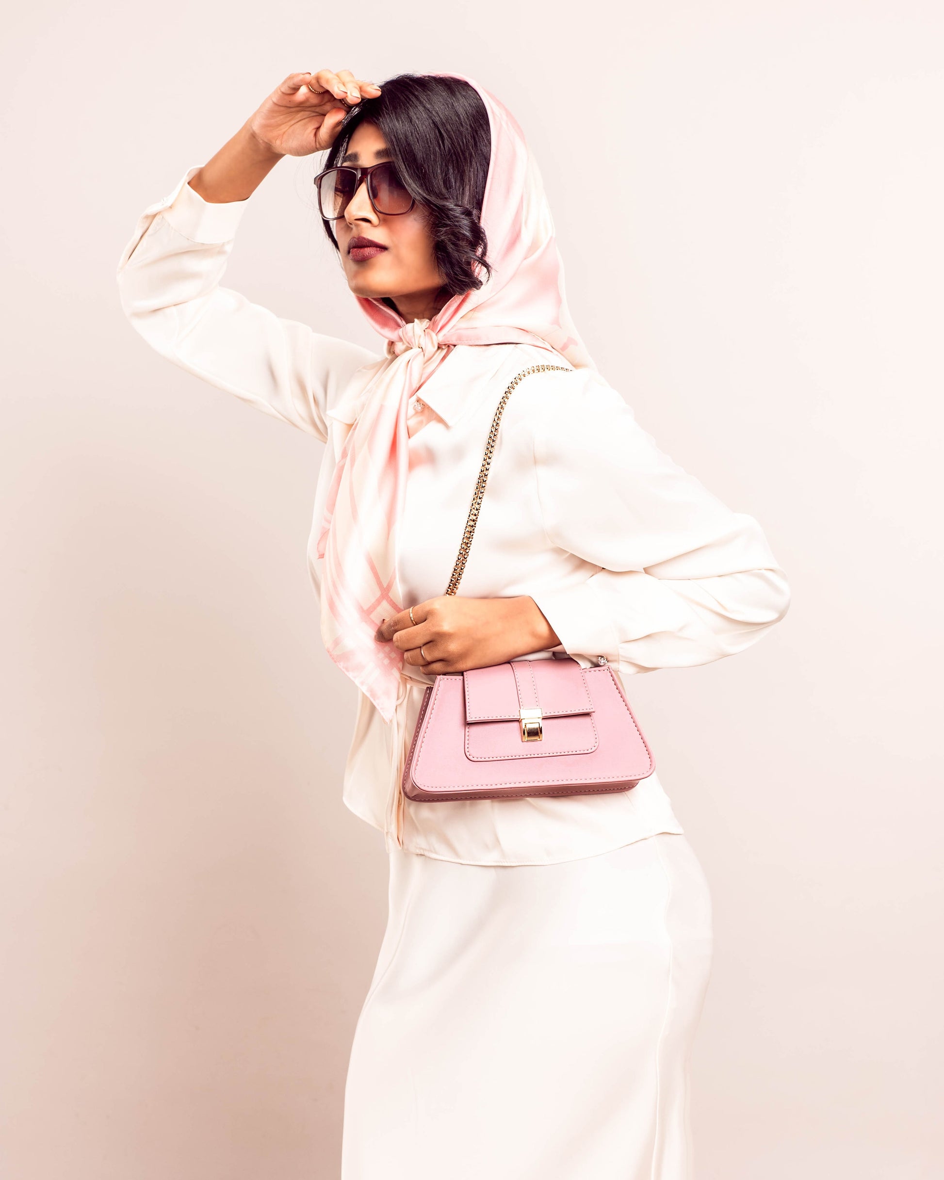 Stylish pink shoulder bag for women from Stylera, worn with a chic outfit