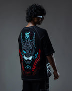 Person wearing a black t-shirt with a glowing dragon design on the back against a dark background