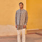 Stylish printed kurta and jacket for men in intricate patterns, paired with white trousers and sandals