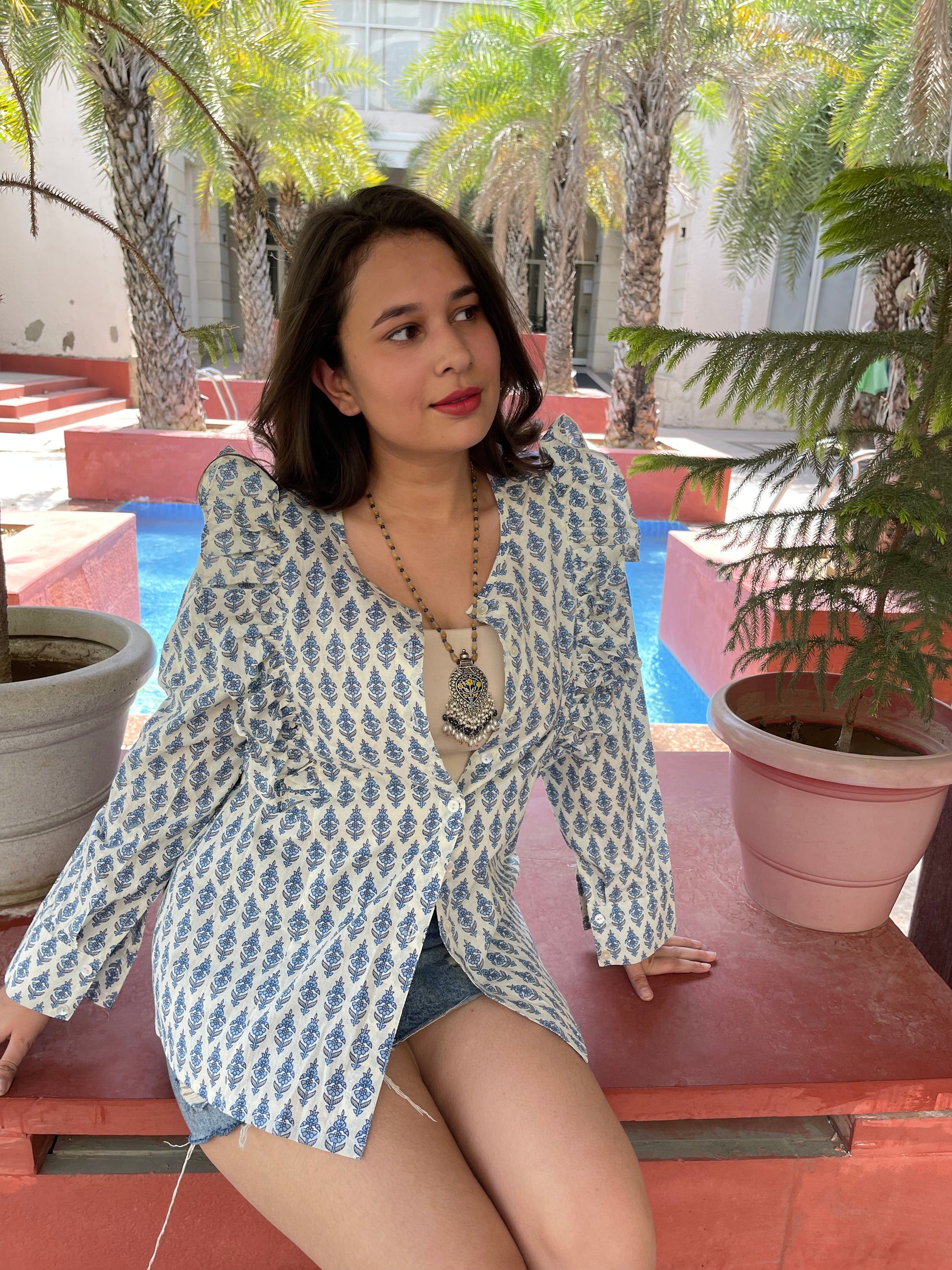Stylish printed long sleeve shirt for women in blue and white pattern paired with denim shorts