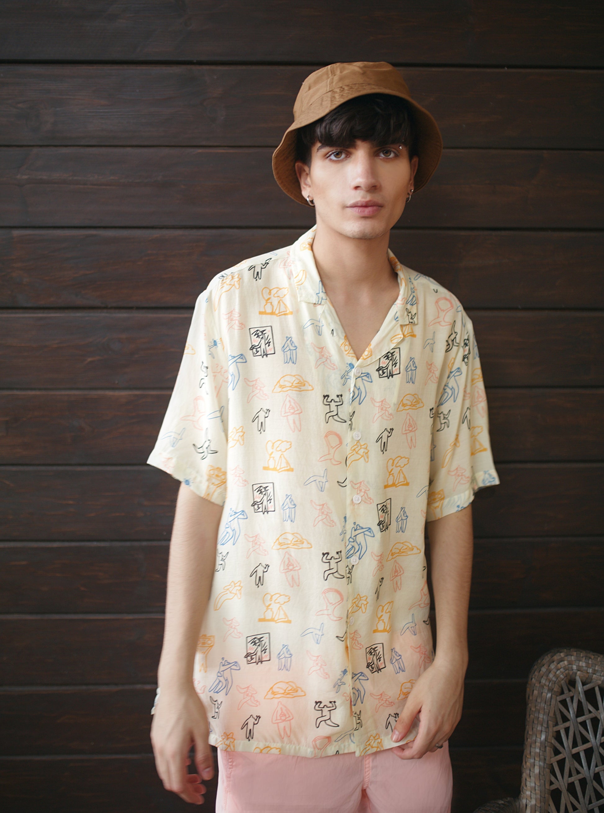 Stylish printed loose fit shirt for men featuring colorful illustrations on a light background