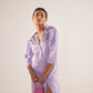 Stylera purple embroidered event dress with three-quarter sleeves and front slit worn with pink handbag