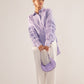 Stylera purple oversized cotton shirt with pleated sleeve details styled with white pants