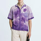 Stylera purple resort shirt for men featuring watercolor floral print short sleeves and camp collar on model