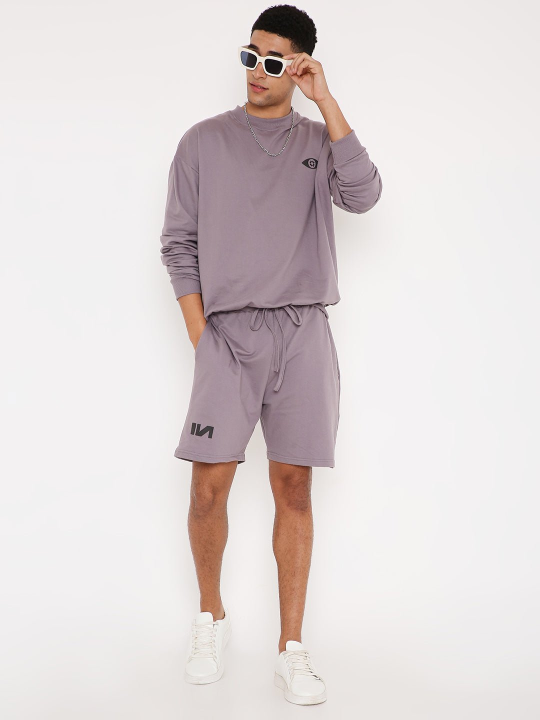 Stylera purple sweatshirt for women displayed on model with matching shorts and white sneakers