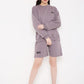 Stylera model wearing purple sweatshirt for women with relaxed crewneck fit paired with shorts