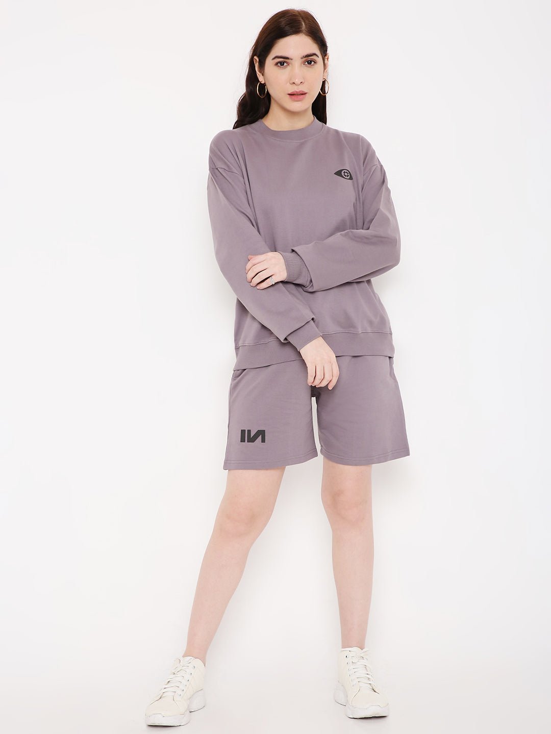 Stylera model wearing purple sweatshirt for women with relaxed crewneck fit paired with shorts