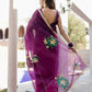 Elegant red and purple saree with handwork, featuring floral embroidery and a rich fabric drape