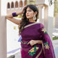 Elegant red and purple saree with handwork displayed on a model, perfect for festive occasions