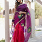 Elegant red and purple saree with handwork, featuring floral designs and a graceful drape