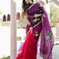 Elegant red and purple saree with handwork displayed by a model outdoors