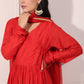 Elegant model wearing a red festive Anarkali gown adorned with traditional accessories