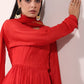 Graceful model wearing a red festive Anarkali gown with elegant accessories and a modest pose