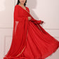 Elegant red festive Anarkali gown flowing gracefully with a stylish silhouette and golden accents