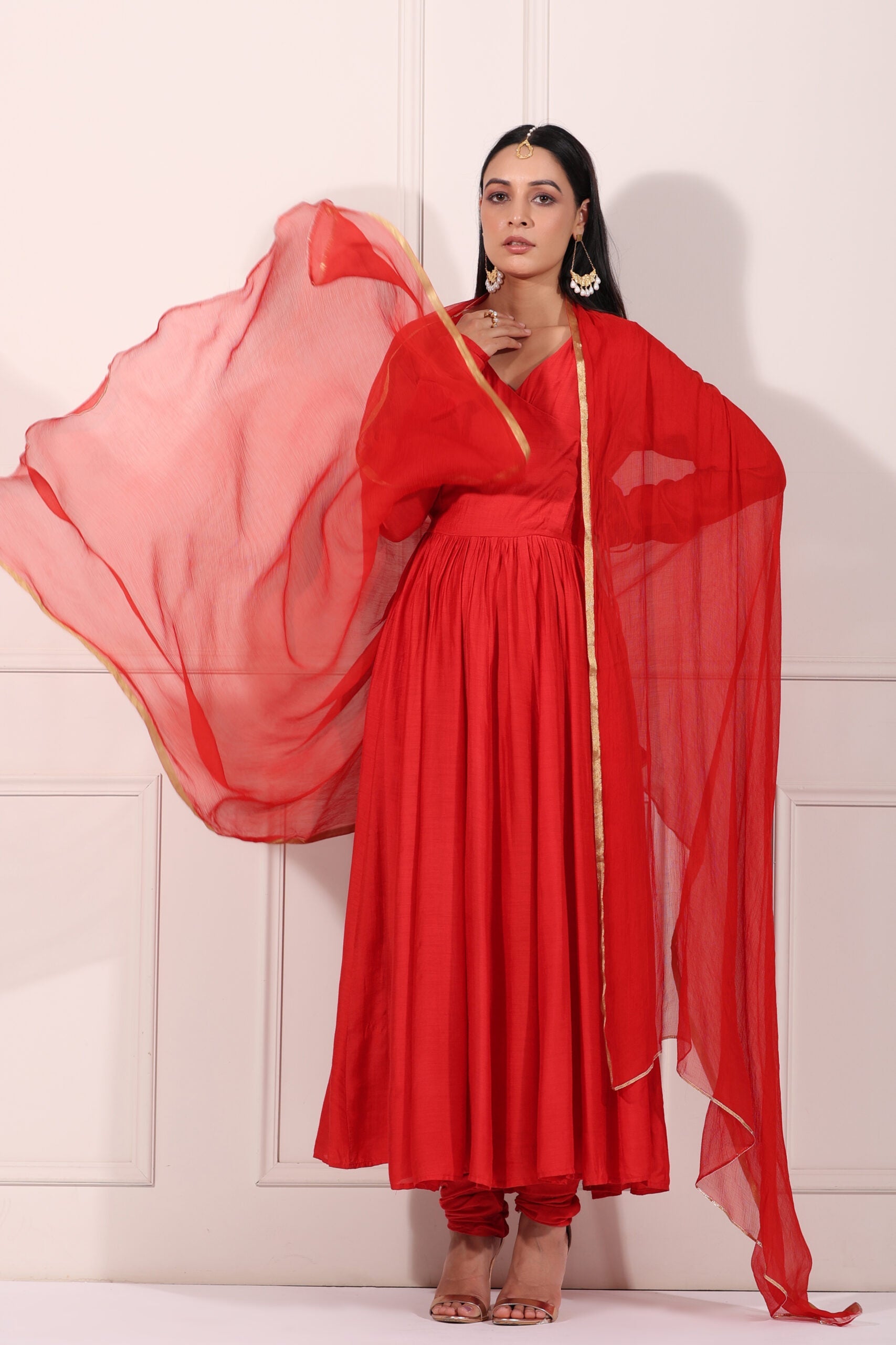 Elegant red festive Anarkali gown with flowing sheer dupatta and stylish design for special occasions