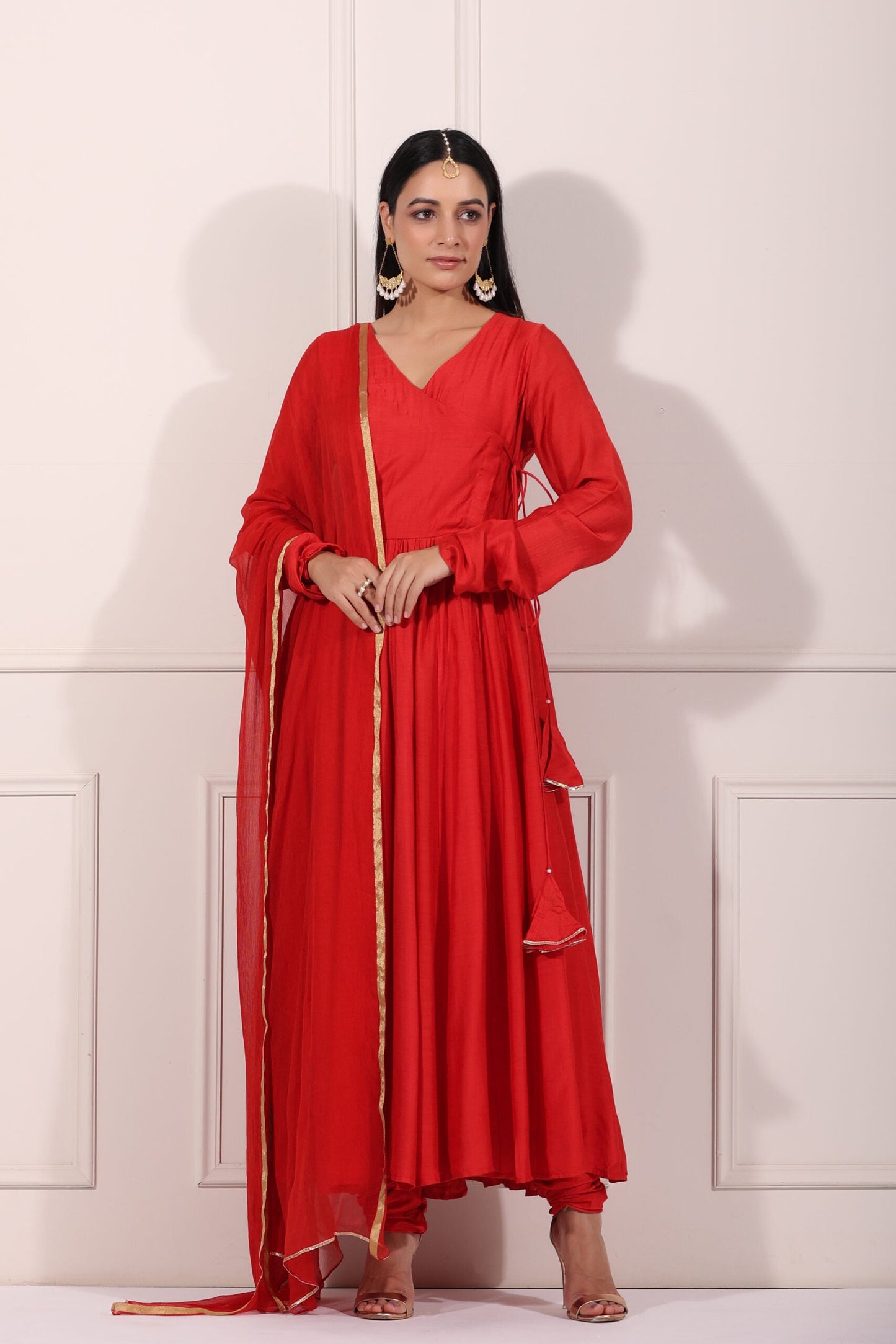 Elegant red festive Anarkali gown with a layered silhouette and matching dupatta for special occasions