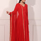 Elegant woman in a red festive Anarkali gown with a flowing silhouette and gold accents