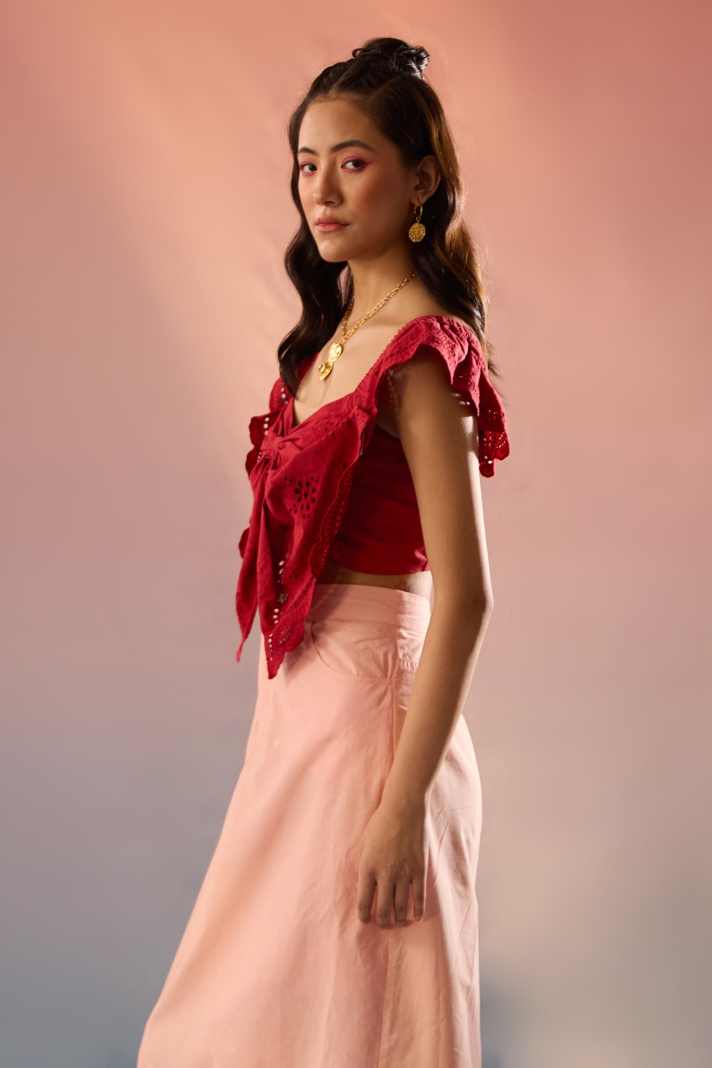 Stylera red top and skirt matching set with eyelet detail and soft pink skirt worn by model