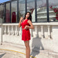 Woman on sunlit terrace wearing red two piece set for women crop sleeveless top and wrap skirt with clear heels