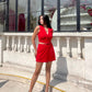 Model in red two piece set for women sleeveless buttoned crop top and mini skirt styled with nude heels outdoors