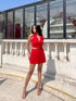 Model in red two piece set for women sleeveless buttoned crop top and mini skirt styled with nude heels outdoors