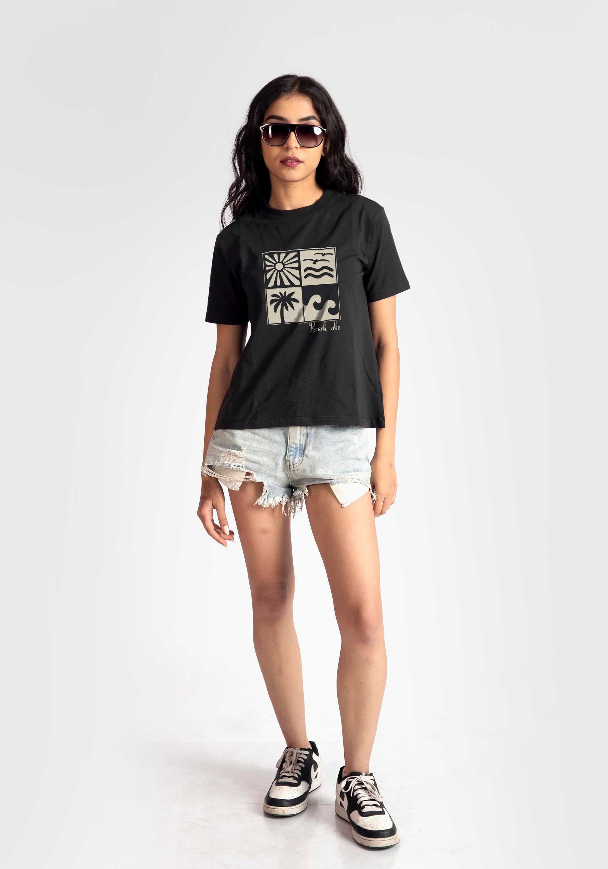Stylera regular fit black t-shirt for women with graphic design paired with ripped denim shorts