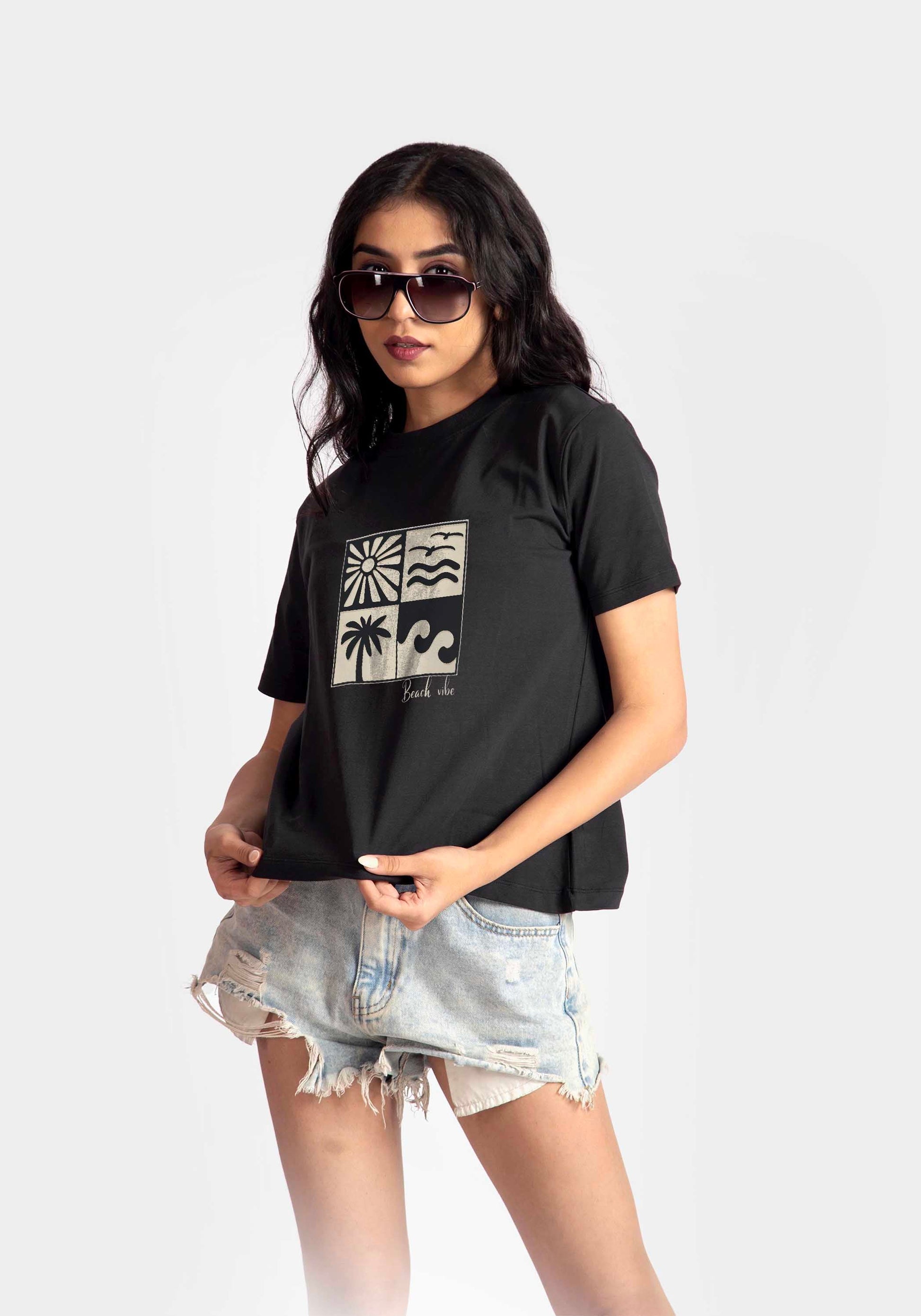 regular fit black t-shirt for women with graphic print worn with denim shorts bt Stylera