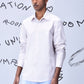 Stylera model wearing pale pink long sleeve button shirt with blue trousers regular fit men's shirt cotton