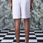 Stylera regular fit pearl grey shorts shown from back on a male model with black sandals