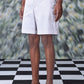 Stylera regular fit pearl grey shorts worn by model standing on checkered floor