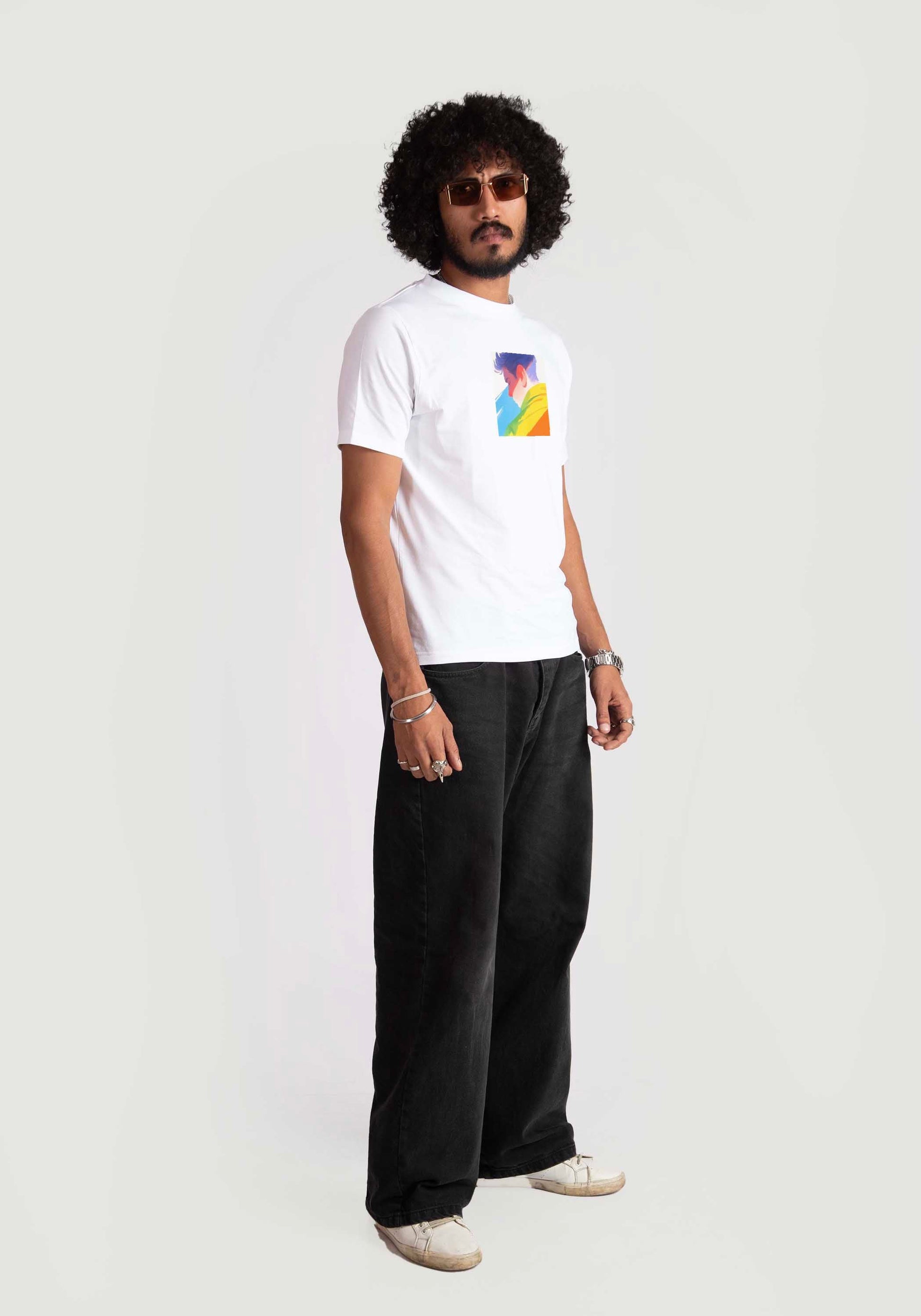 Man wearing regular fit Stylera  white tee with colorful graphic and black pants