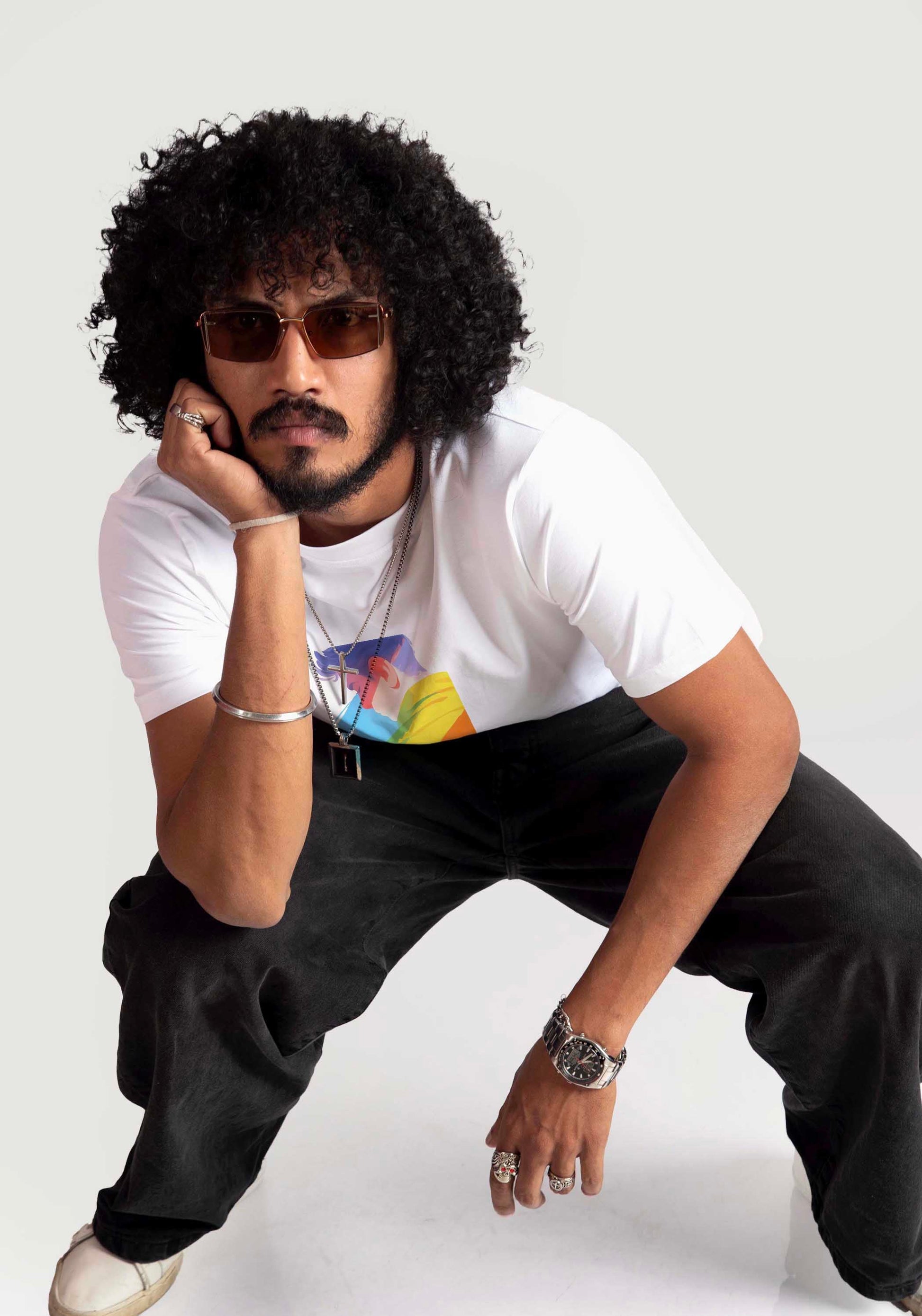 Man wearing Stylera regular fit white tee with graphic design paired with black pants and sunglasses