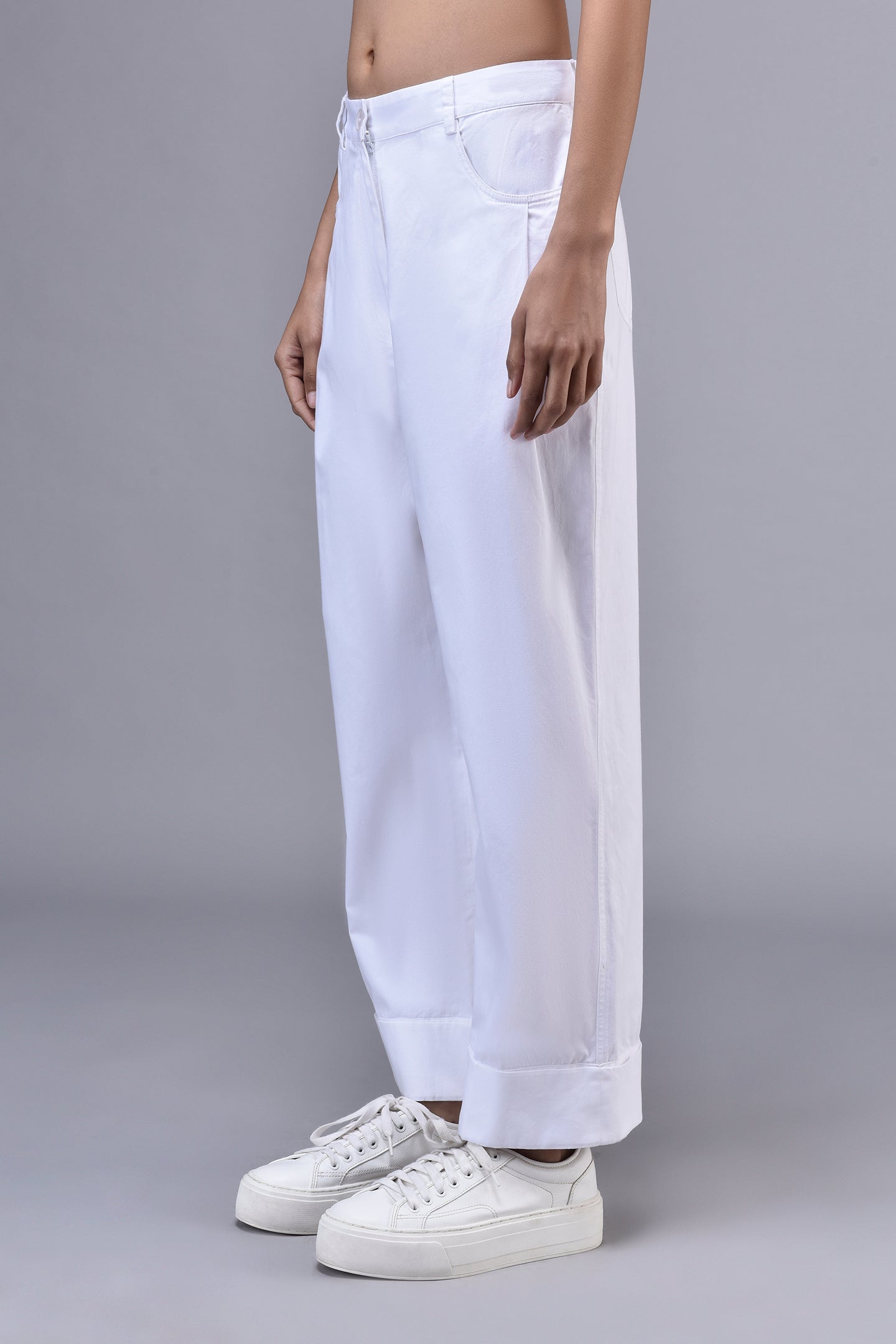 Stylera white cuffed trousers on model showing relaxed fit cotton pants for women